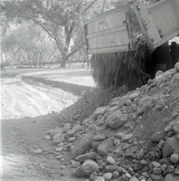 Dump truck dumping gravel and rocks to be used for road work along the scenic canyon drive near the Grotto.
