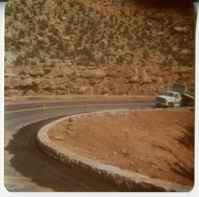 Truck along road curve along the Zion-Mt. Carmel Highway switchbacks during the widening of the retaining wall.