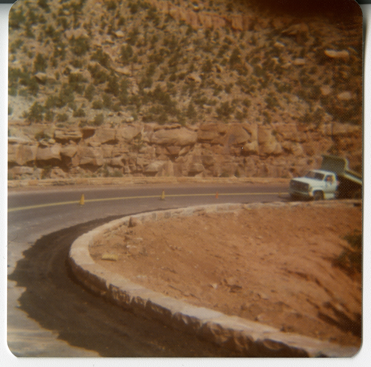 Truck along road curve along the Zion-Mt. Carmel Highway switchbacks during the widening of the retaining wall.