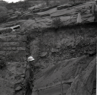 Man working on retaining wall repairs along East Rim road.