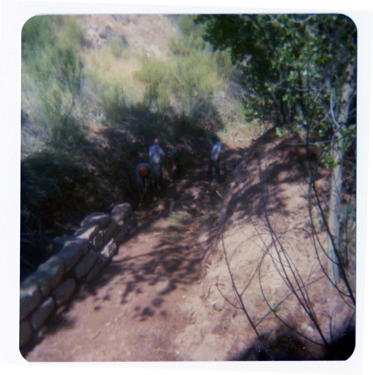 Four men working on section of trail near new Grotto footbridge.