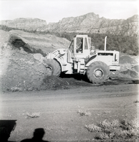 Excavator piling dirt during road grading to Chamberlain Ranch and the Narrows.