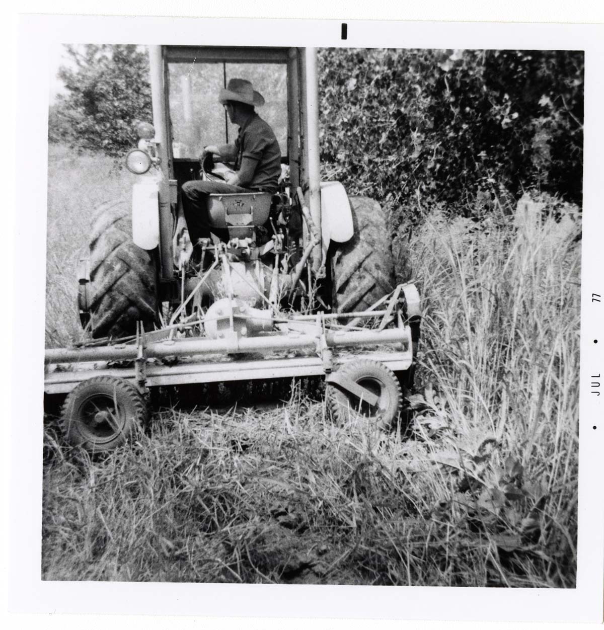 Construction vehicle cleaning and clearing in campground area.