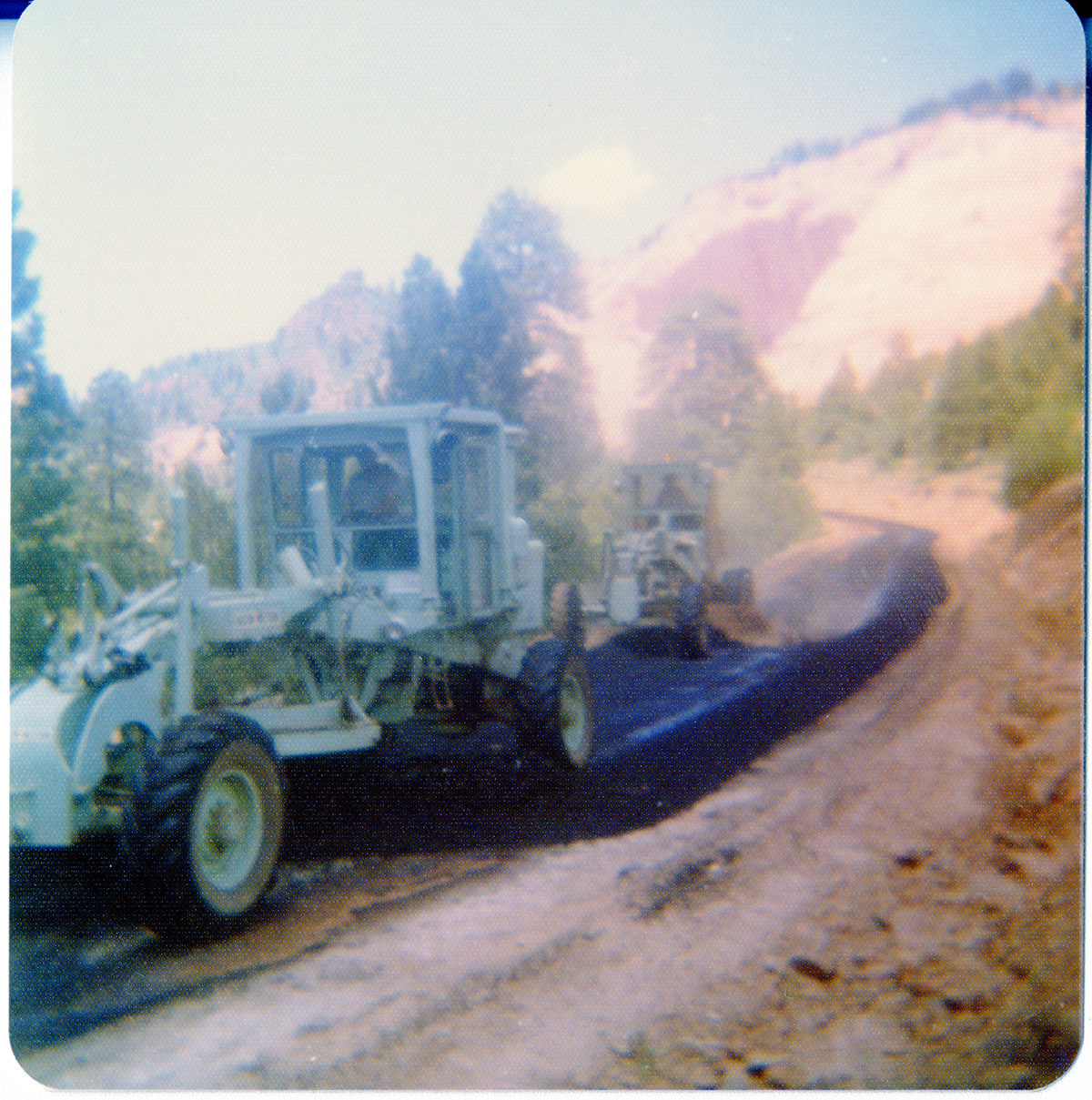 Asphalt being laid by construction vehicles during road work along the Kolob Terrace road.