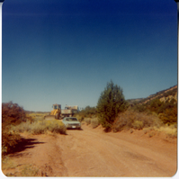 Construction vehicles driving on dirt road in Kolob Canyon.