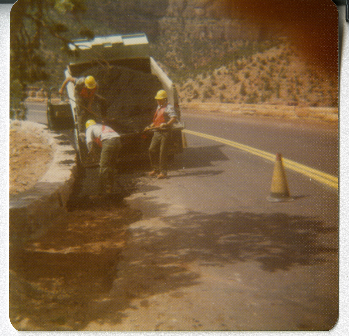 Men work on widening the retaining wall from truck along the Zion-Mt. Carmel Highway switchbacks.
