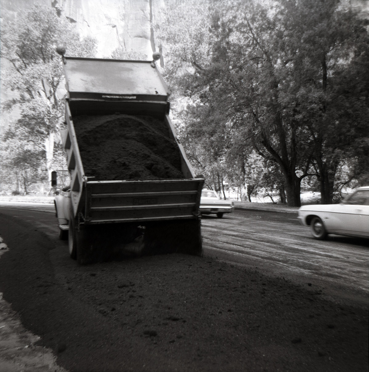 Dump truck dumping dirt during resurfacing of roads in Zion.