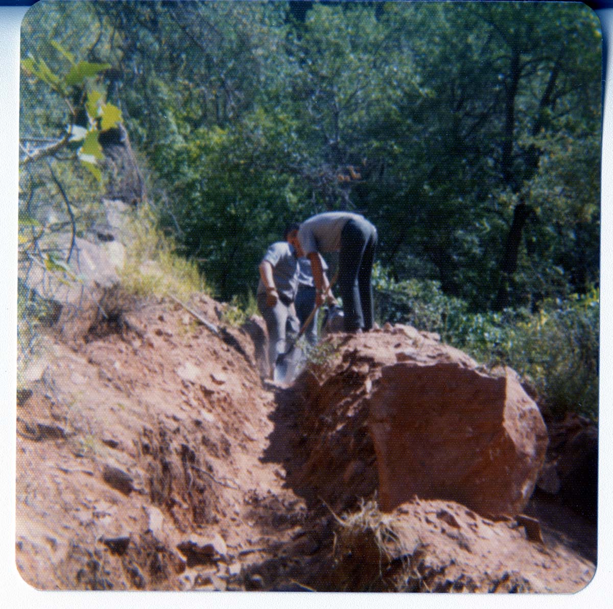 Workers excavating ditch.