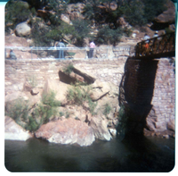 Men working on trail by the new Grotto footbridge. Overview of stone abutment for bridge and trail along Virgin River.