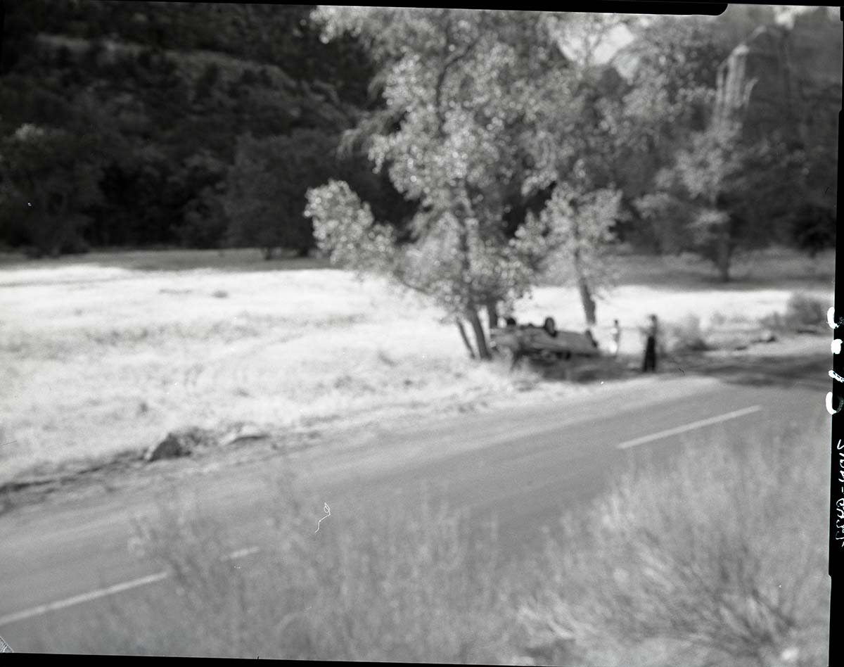Auto accident 6 miles south of Zion Lodge. Car overturned just off road.