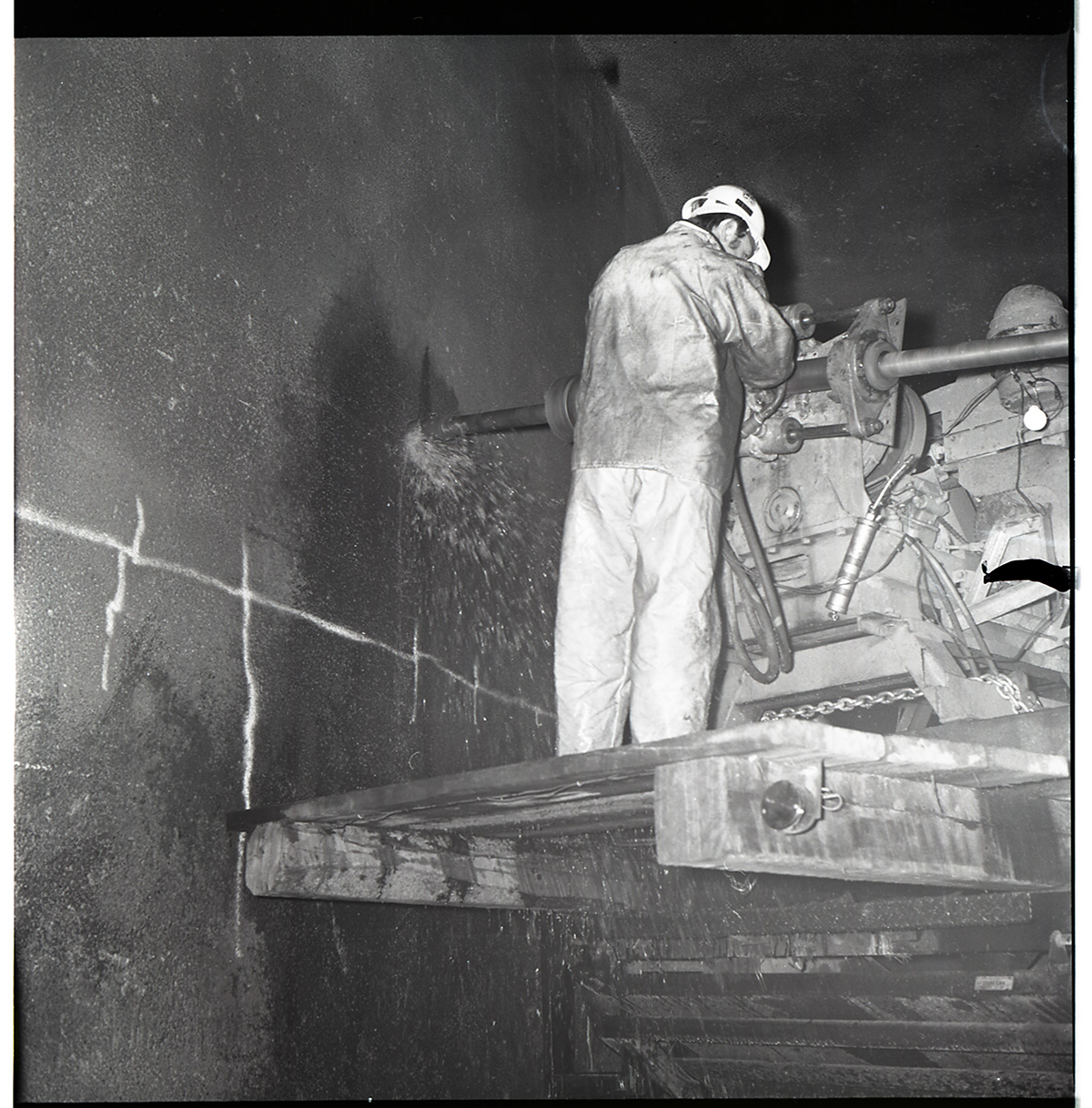 Worker works with drill rig during test hole drilling in Zion-Mt. Carmel tunnel.