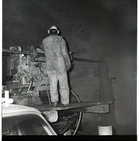 Worker works with drill rig during test hole drilling in Zion-Mt. Carmel tunnel.
