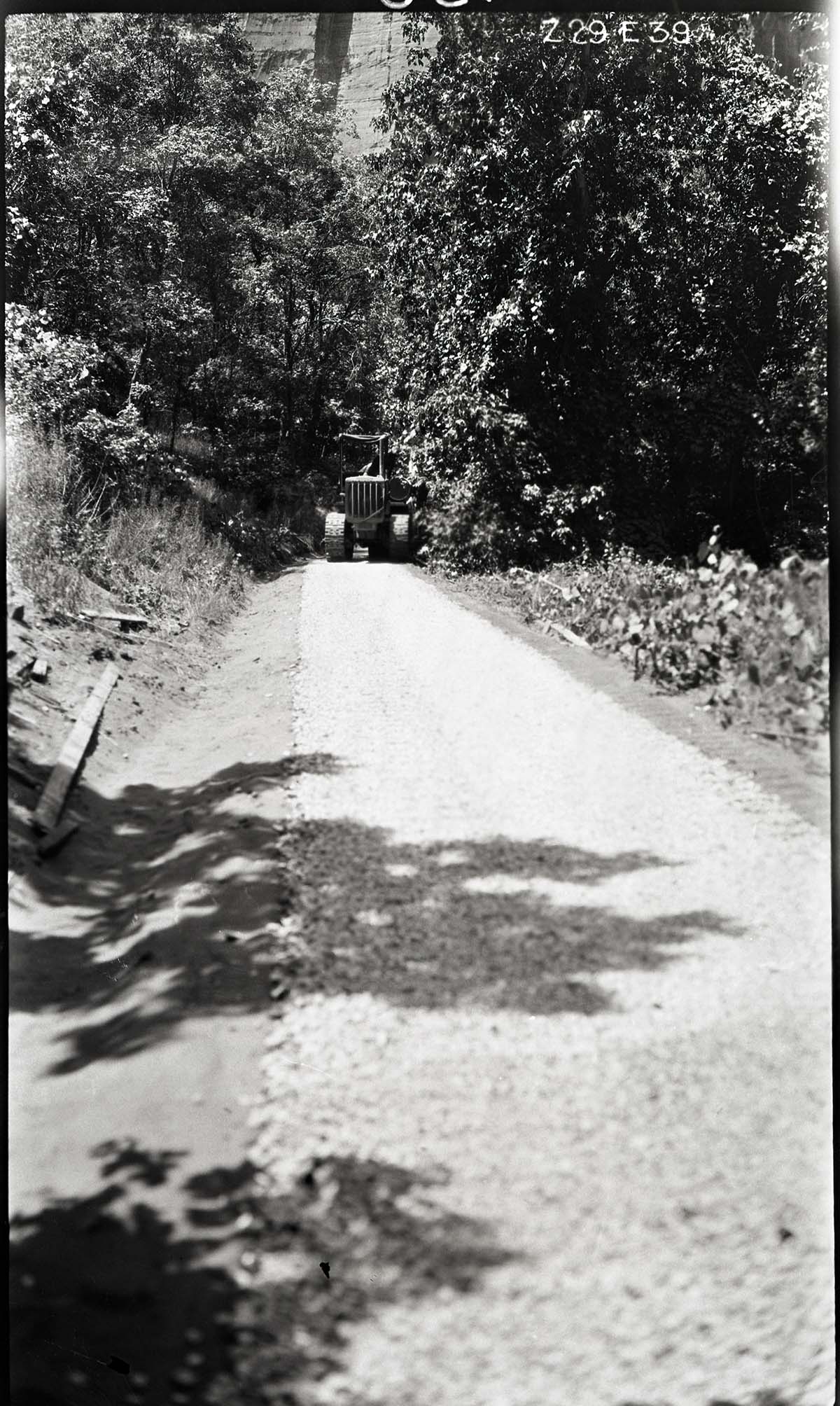 Narrows Trail construction- rolling on the locking course with a caterpillar tractor pulling the roller.