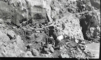 Narrows Trail construction- view of cement and rubble masonry wall at station 30-60. Five workers are drilling with a draft horse.