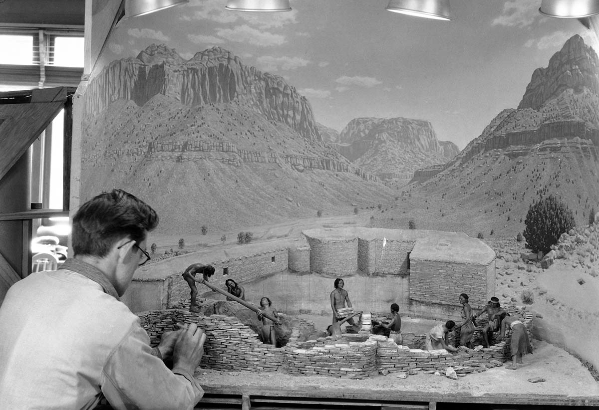 Western Museum Laboratory (WML) worker assembling the Zion Museum's Indian Pueblo diorama exhibit.