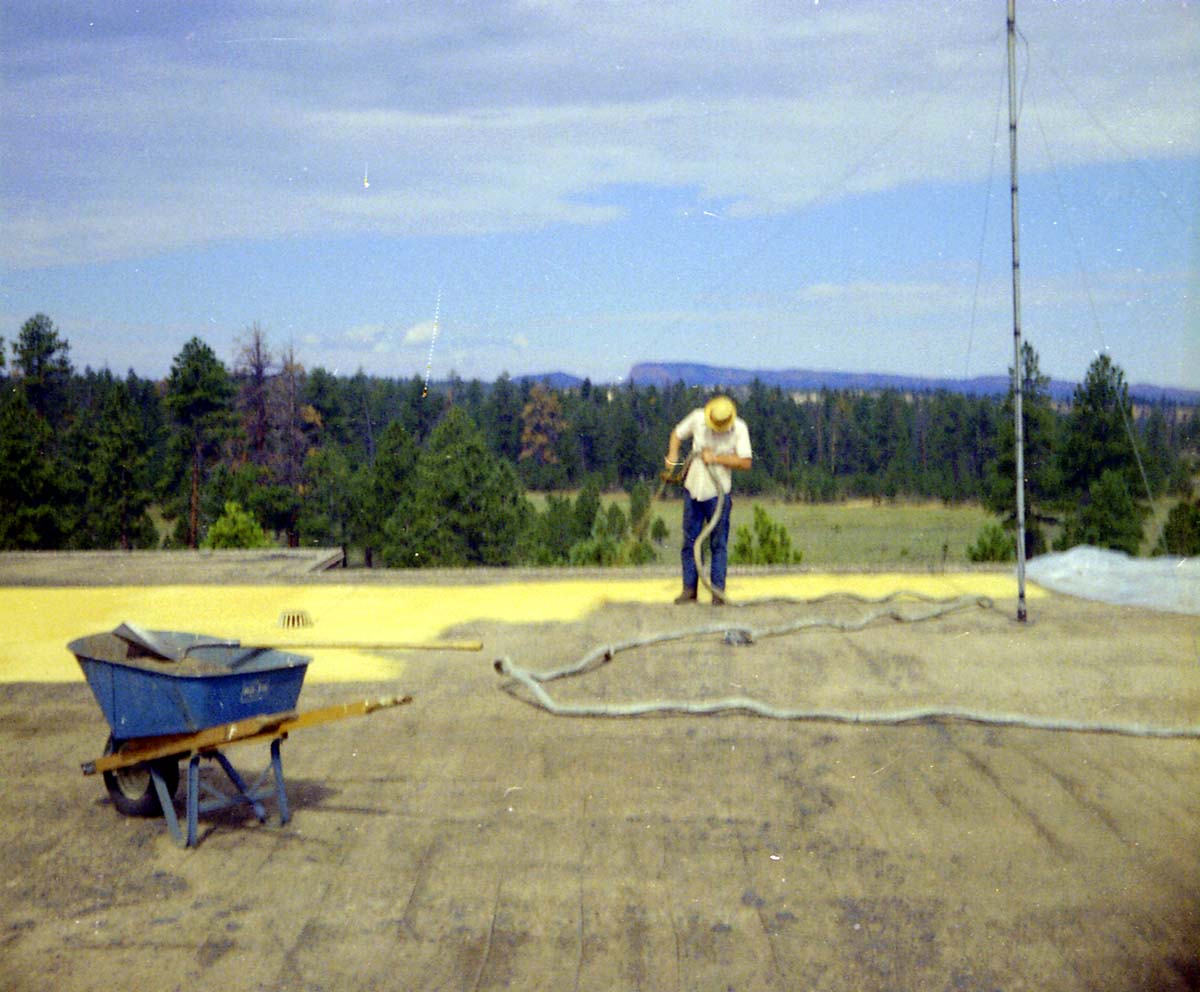 Man spraying foam sealant during reroofing project. Bryce Canyon National Park.