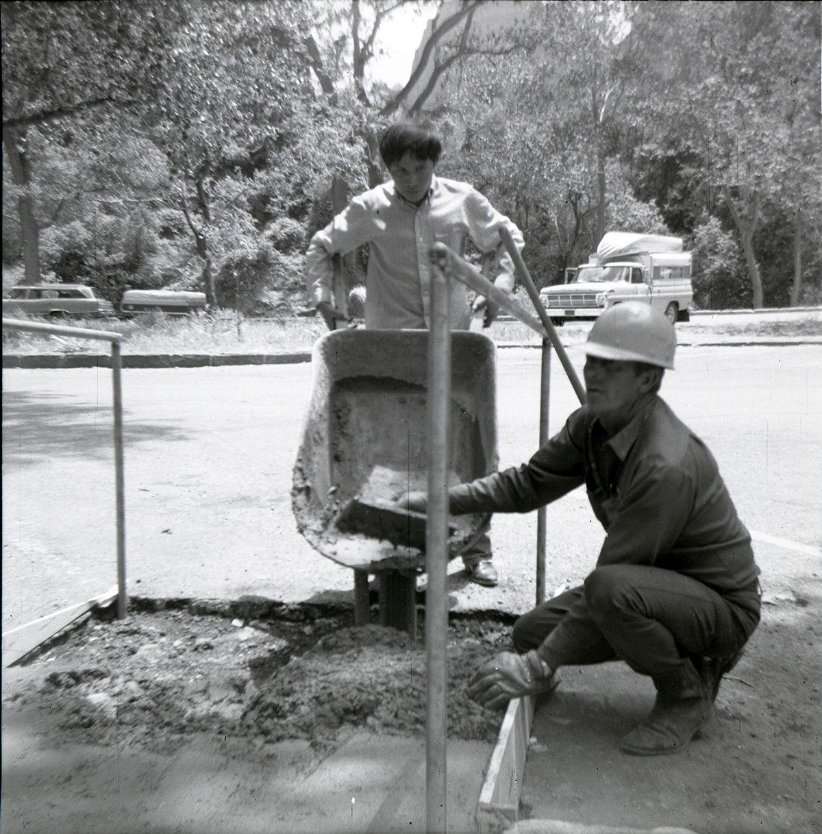Men using wheelbarrow for road work on the Great White Throne parking area.