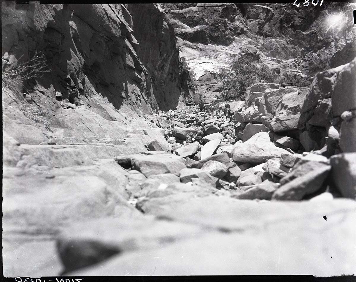 Damage done by storm of July 25, 1954 to West Rim Trail. Looking down on switchbacks leading up Refrigerator Canyon.