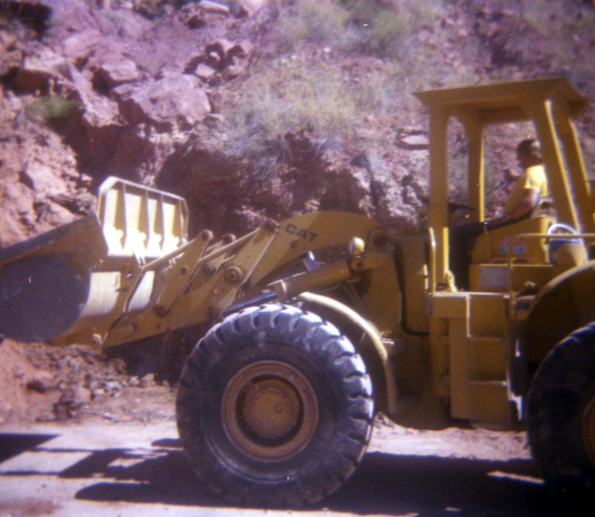 Color Photo of a rock slide along road.