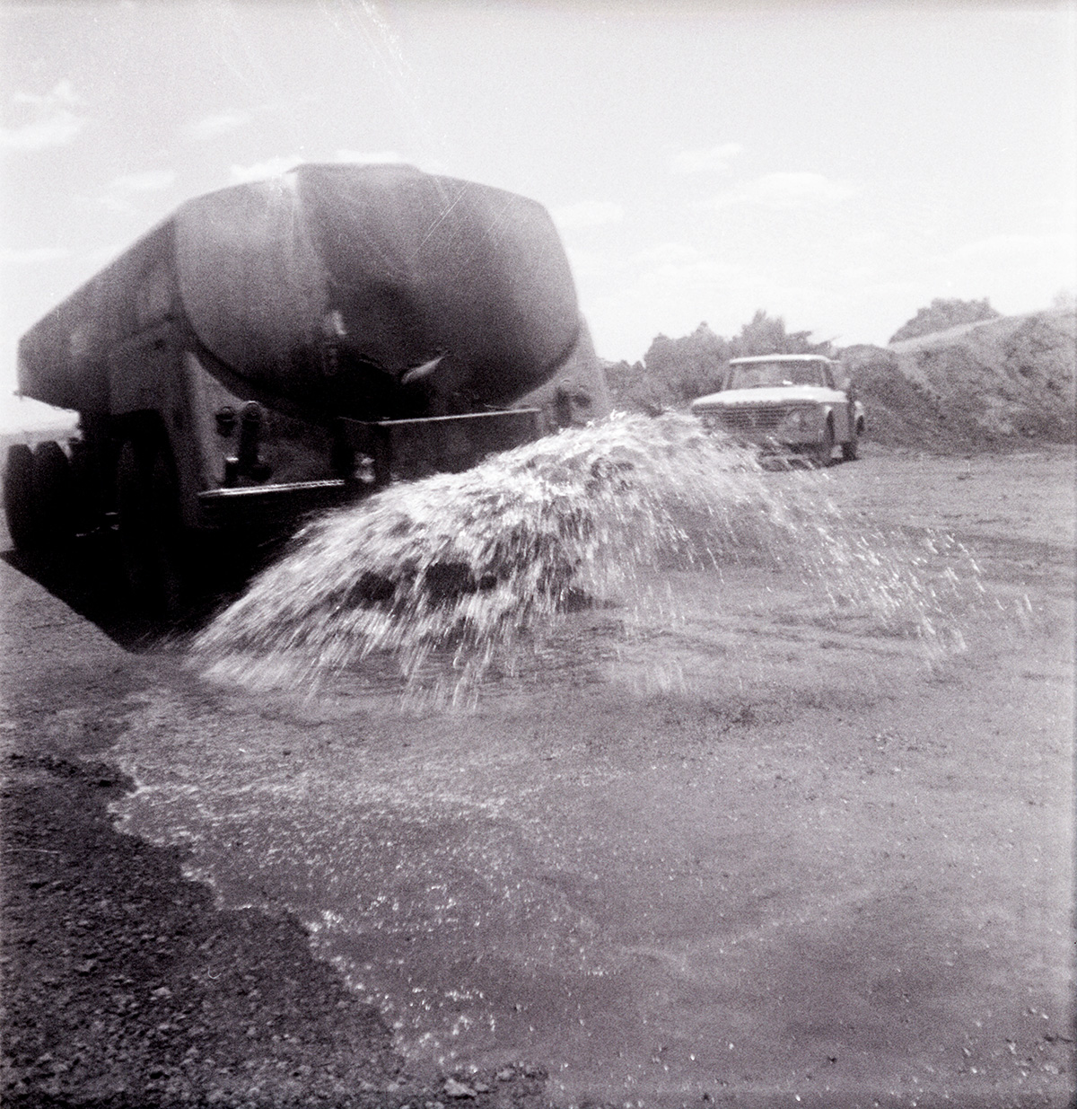 Construction vehicle spraying chipsealing of Kolob Canyon Road.