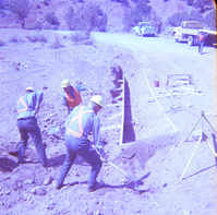 Men digging and repairing road.