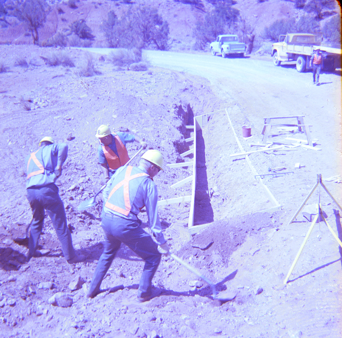 Men digging and repairing road.
