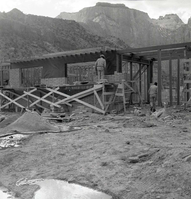 Two workers 'laying up' split blocks for visitor center wall during the Mission 66 Visitor Center and Museum construction.