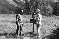 BW Photos of ranger-led hike / yucca talk. Visitors standing next to Backcountry Manners sign.