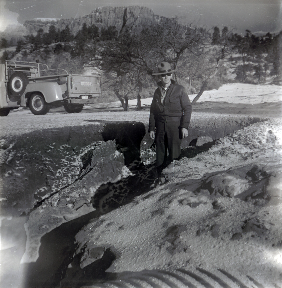 Man inspecting road work progressing along the scenic canyon drive near the Grotto.