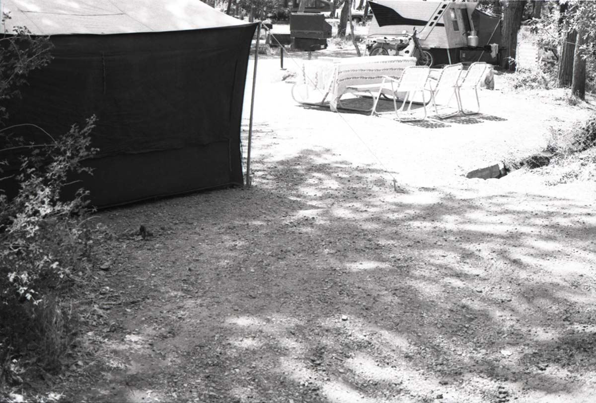 Tent, tables, and chairs set up in a campsite in South Campground.