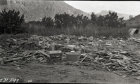 Unsightly conditions such as these occurred along the highway after original owners moved away. Small table, washtub and water spigot are visible among buildings debris.