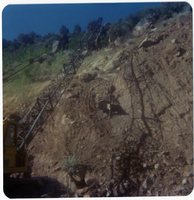 Crane moving large rocks on side of mountain during road work/repair in Kolob Canyon.