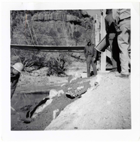 Workers during the protection/stabilization of the footings for the old Birch Creek suspension footbridge.