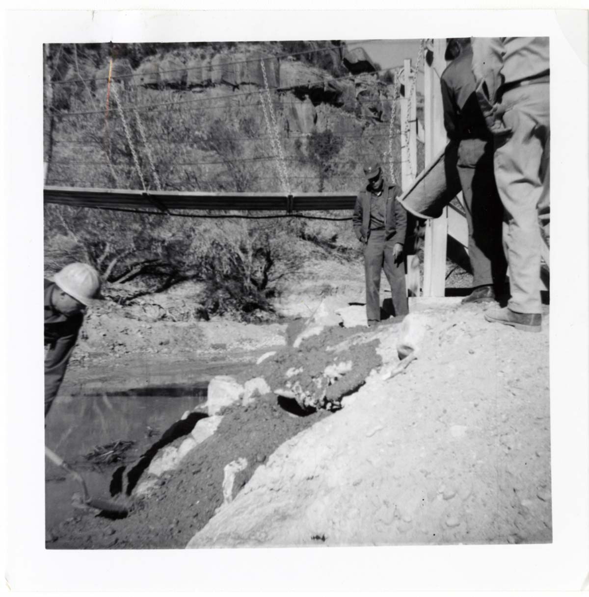 Workers during the protection/stabilization of the footings for the old Birch Creek suspension footbridge.