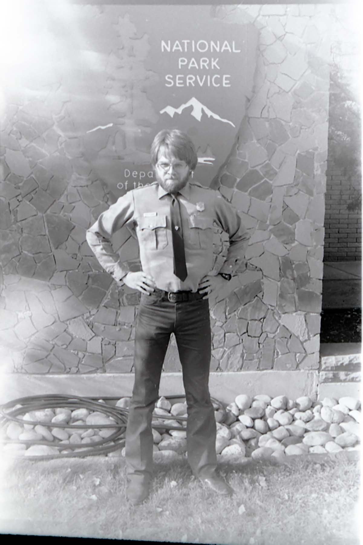 Man with beard flexing muscles.