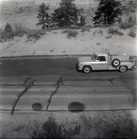 Truck driving on road during east side road repair and turn out construction.