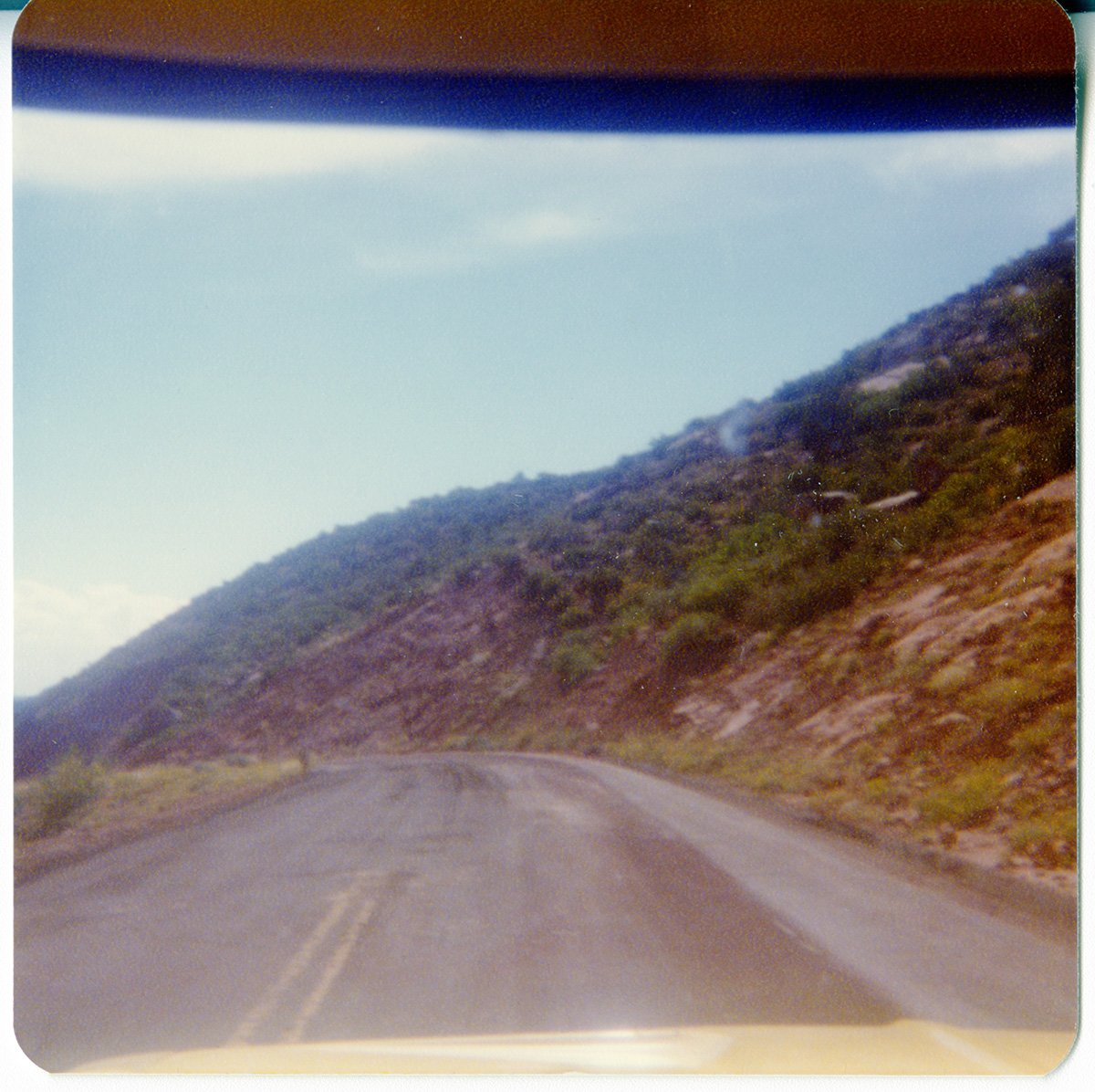 View along the Kolob Terrace Road - North Unit through the windshield of a vehicle.