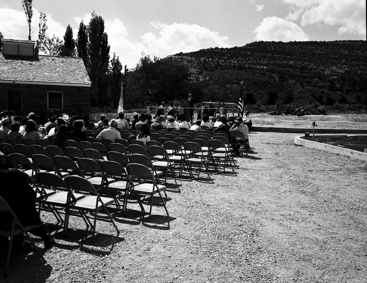 Man addressing visitors at the dedication of new Tribal and National Park Service Visitor Center and 50th anniversary at Pipe Spring National Monument.