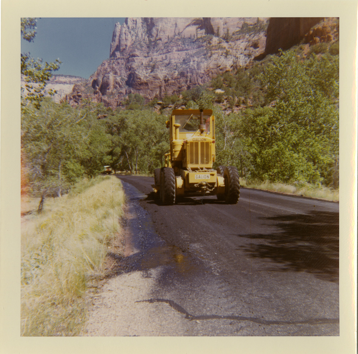 Tractor performing shoulder work along route 2 parking areas.