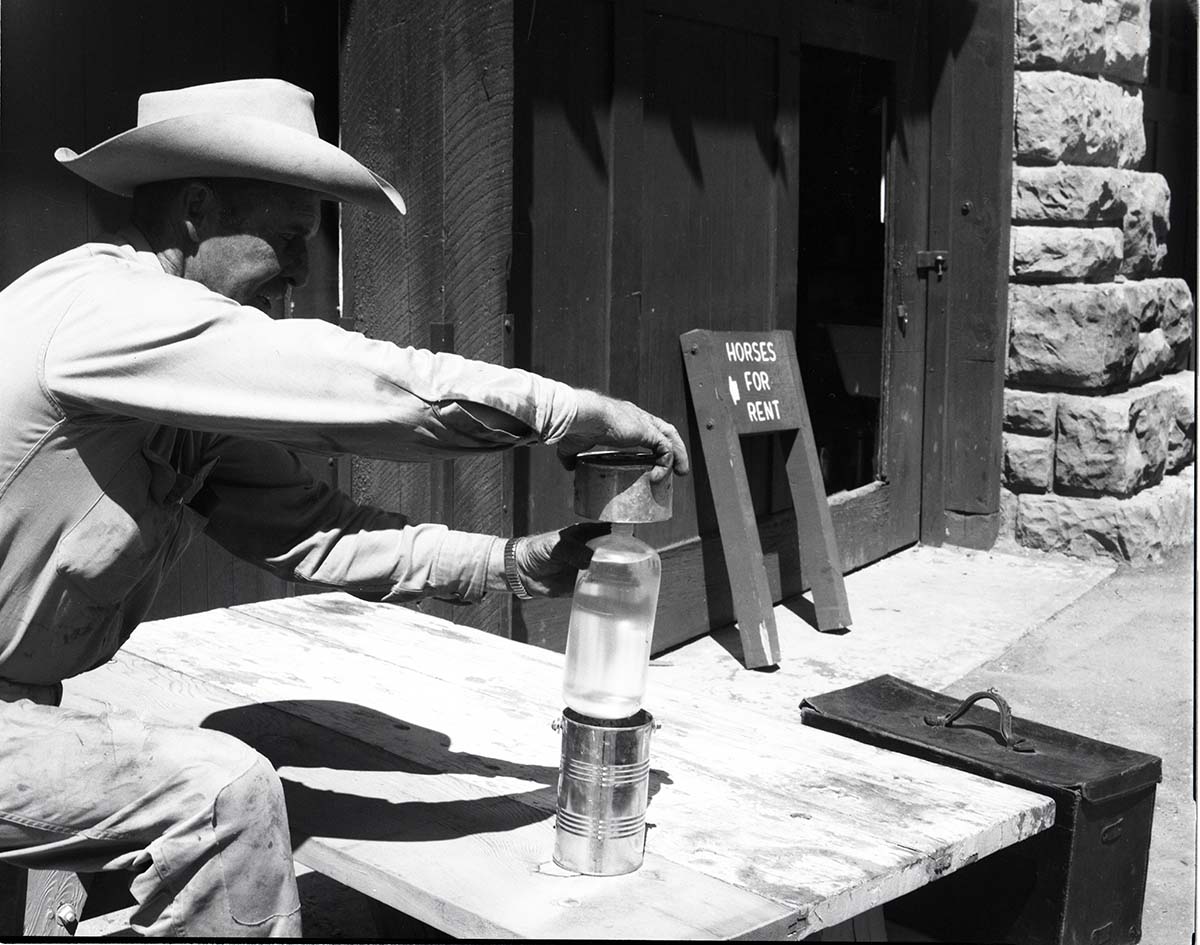 BW Photos of maintenance equipment. Man holding can over bottle. Sign in background reads: Horses for Rent.