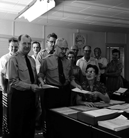 Superintendent Paul R. Franke presenting awards to Ruth Byrd and Carl E. Jepson with members of office staff looking on, headquarters building.