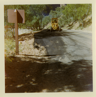Tractor performing shoulder work along route 2 parking areas.