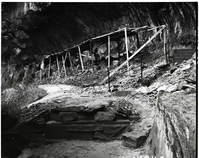 Repair of Weeping Rock Trail and concrete steps showing stone work and laborer working on stone work.