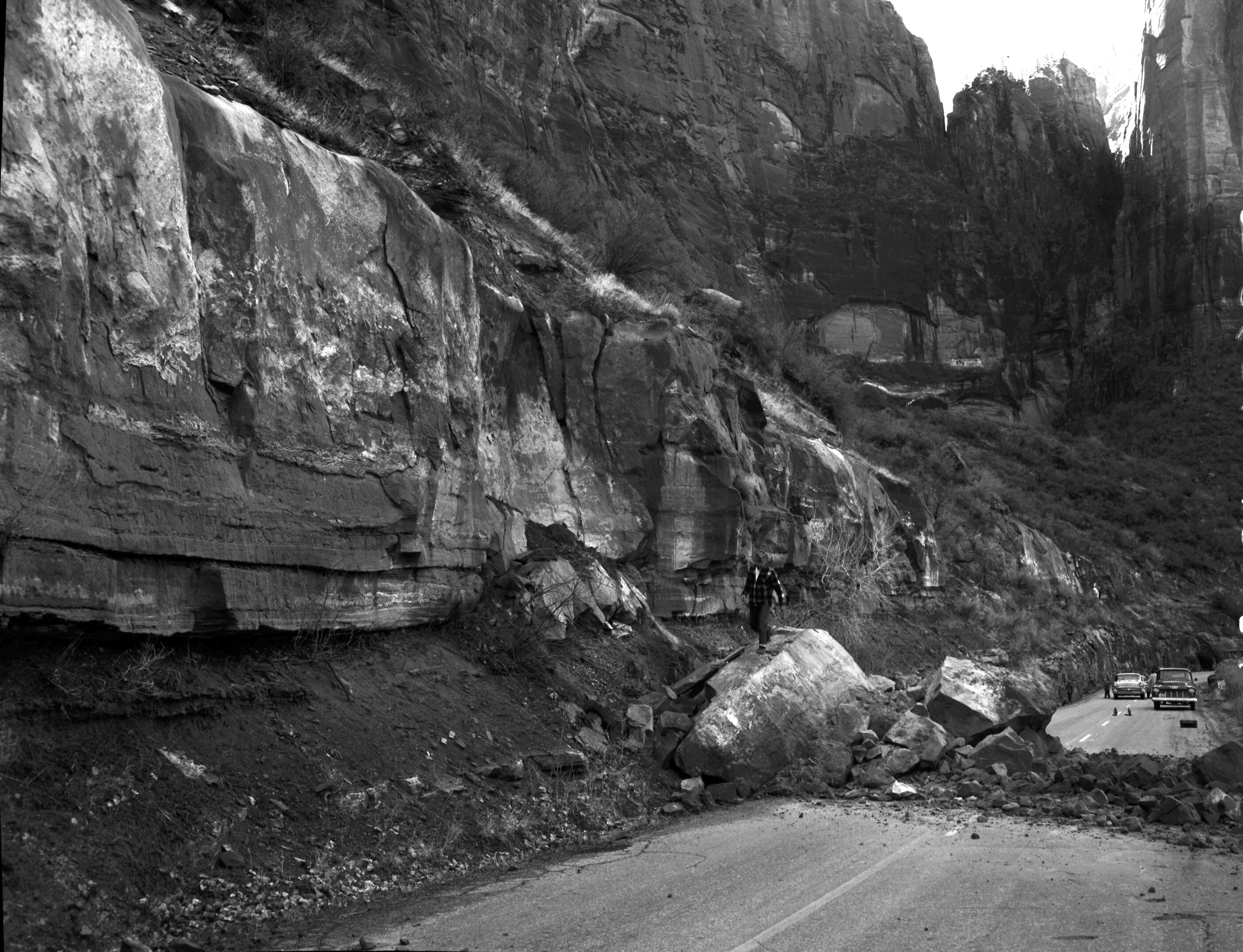 Rock fall behind Chief Ranger Fred Brueck's residence. Image shows two men working.
