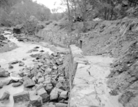 Flood damage to rock wall on Virgin River, a quarter mile south of Court of Patriarchs. Record of damage or defective workmanship.