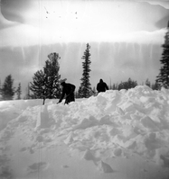 BW Photos showing rangers digging out the visitor center from snowdrift.