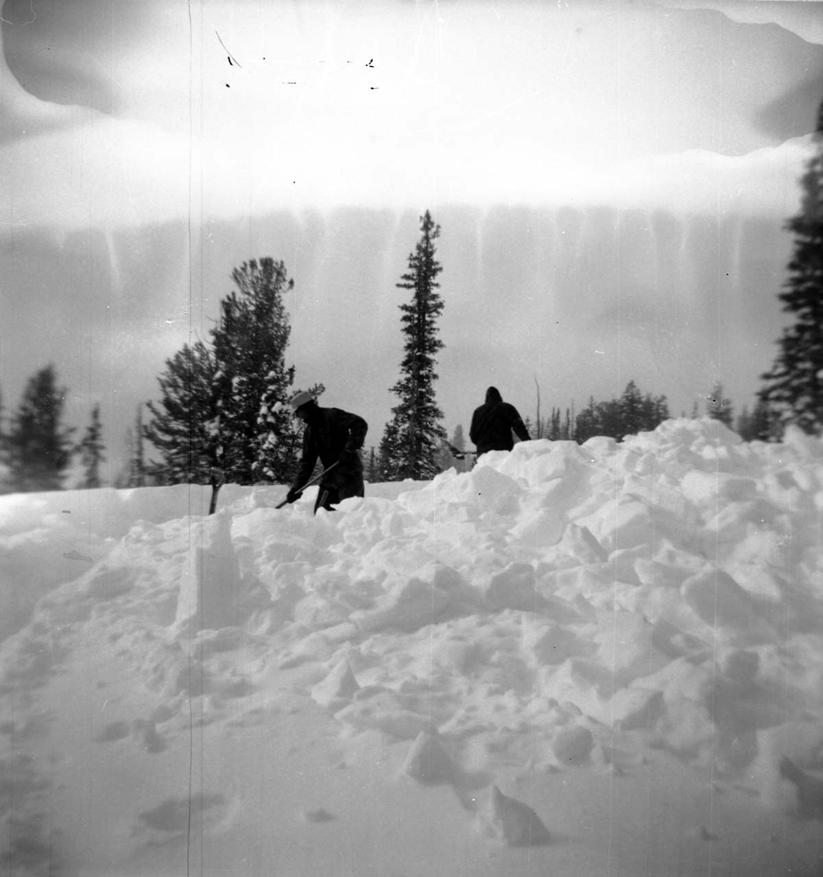 BW Photos showing rangers digging out the visitor center from snowdrift.