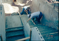 Men working on the building of a staircase during the construction of headquarters addition.
