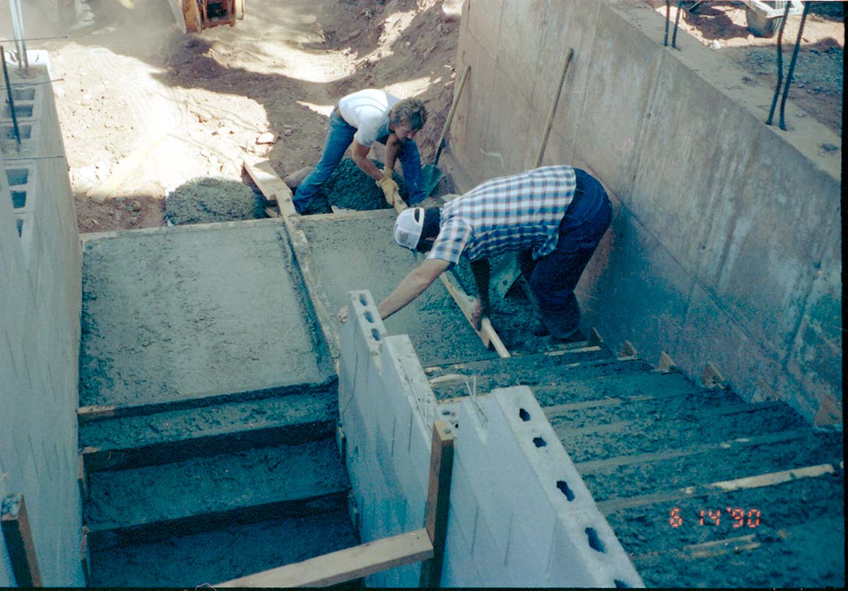 Men working on the building of a staircase during the construction of headquarters addition.