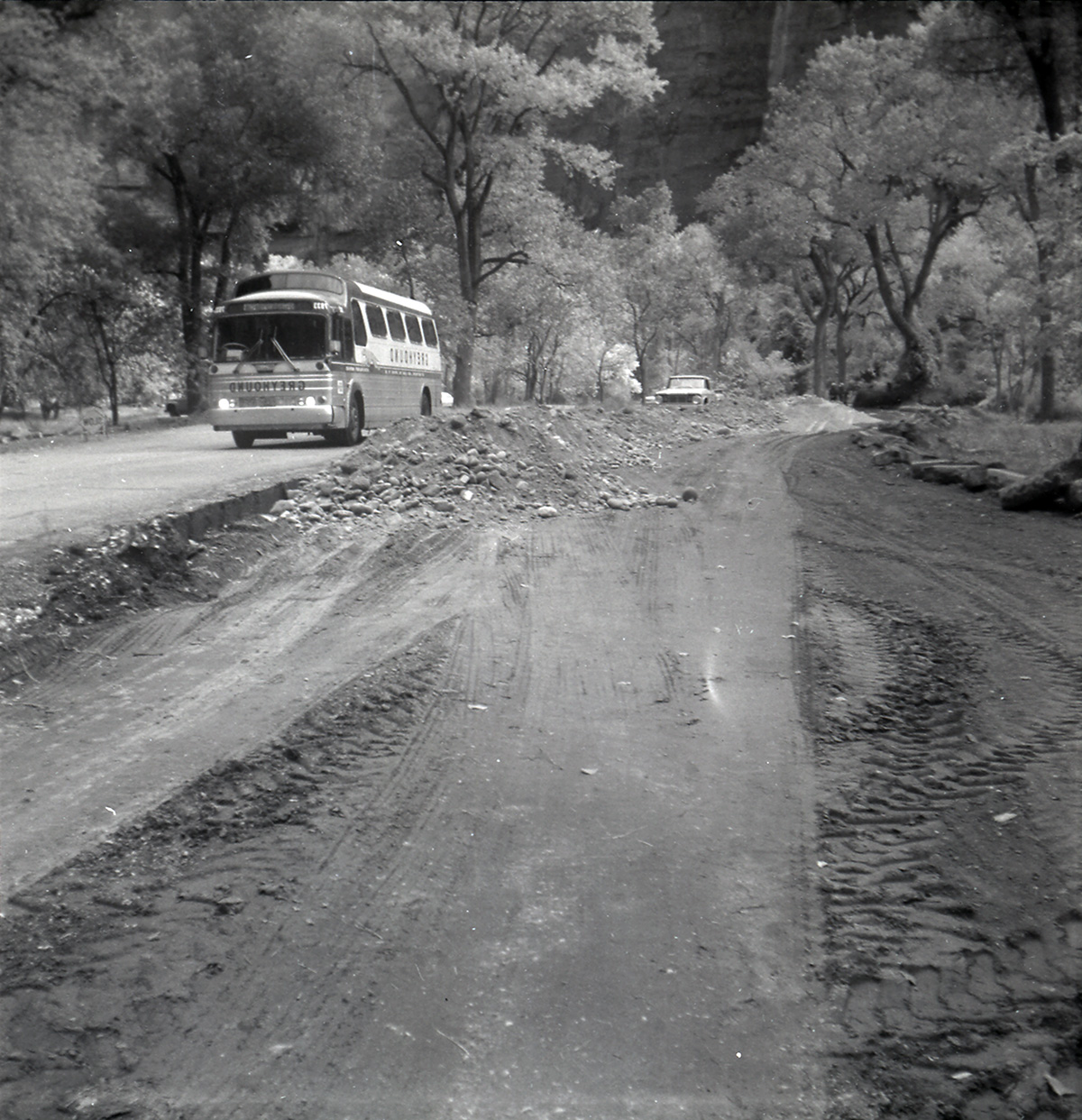 Shuttle bus driving alongside road work long the scenic canyon drive near the Grotto.